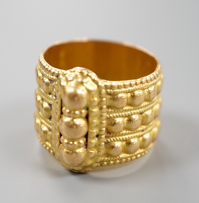 A Middle Eastern embossed yellow metal ring, size O/P, 14.8 grams.